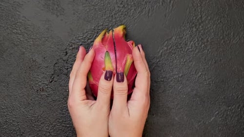 Halved Dragon Fruit Displayed with Purple Nails