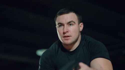 Man Exercising With Battling Ropes In Gym