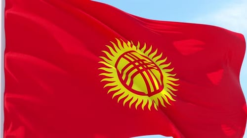 Vibrant Kyrgyzstan Flag Waving Against Blue Sky