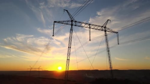 High Voltage Tower with Electric Power Lines at Sunset