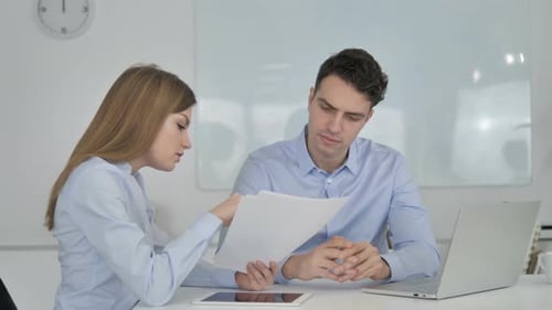 Business Colleagues Working on Documents in Office, Paperwork