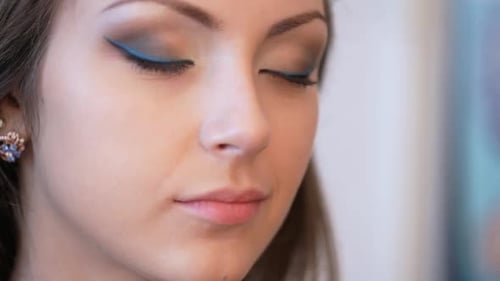 Woman Receives Makeup Application with Brush Close Up