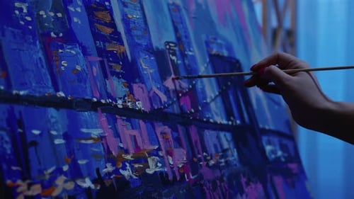 Artist Painting a Vivid Cityscape on Canvas