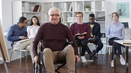 Man in Wheelchair with Diverse Group of Young Adults