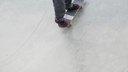 Skater Practicing in the Autumn Concrete Skate Park Making Tricks and Rides in Ramp