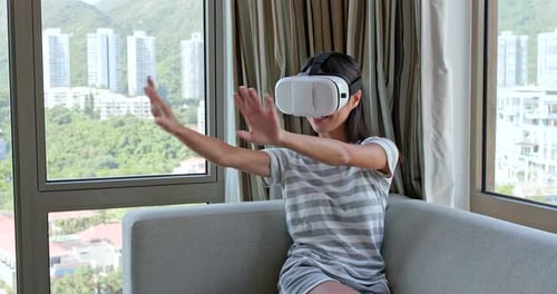 Woman Using VR Headset at Home, Interacting