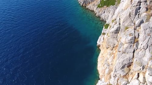Rocky Steep Wall Cliff by the Seashore in Untouched Sea