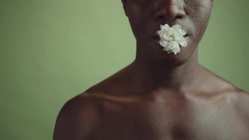 Striking Portrait of Person with Flower in Mouth