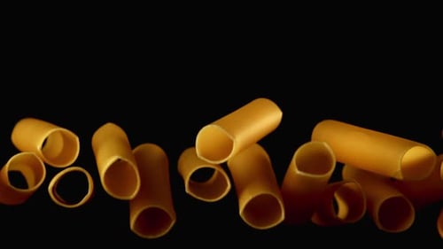 Pasta Tubes Floating on a Black Background