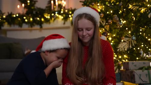 Kids in Santa Hats Enjoying Tablet at Christmas