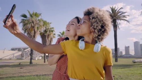 Gay Couple of Girlfriends Take a Picture with Their Cell Phones