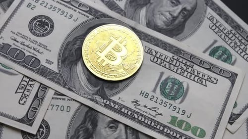 Bitcoin Coin on One Hundred Dollar Bills