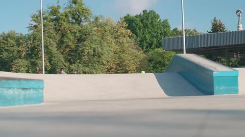 Young Adult Rides BMX Bike at Skate Park