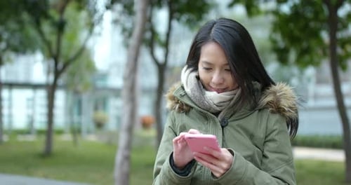 Woman use of mobile phone at park