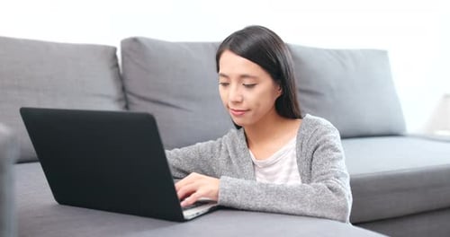 Woman Using Laptop Computer in Home Interior
