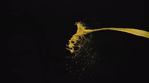 Dynamic Yellow Paint Splash Against a Black Backdrop