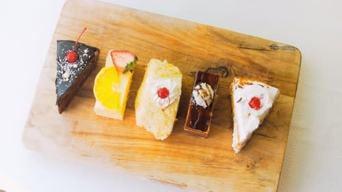 Assorted Cake Slices on Wooden Board
