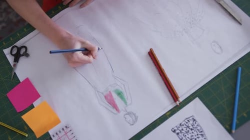 Caucasian woman drawing in fashion office