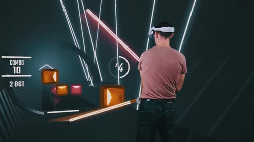 Man Plays VR Rhythm Game with Light Sabers