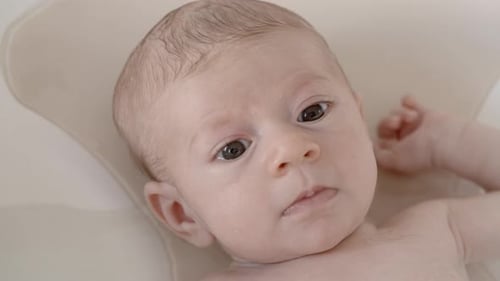 Baby Lying in Bath Water Close Up
