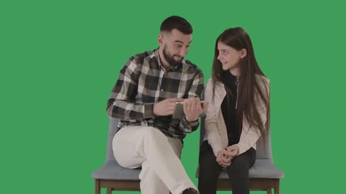Man and Child Interact With Tablet on Green Screen