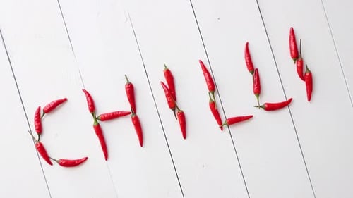 Creative Chili Pepper Still Life on White Wood