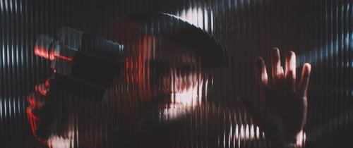 Man with Vintage Camera Behind Textured Glass