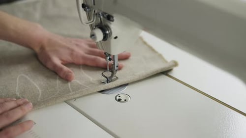Hands Sewing Fabric with Sewing Machine