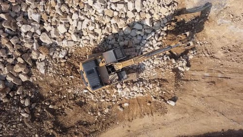 Overhead View of Excavator in Open Air Quarry