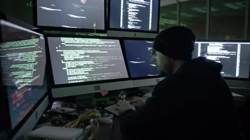 Coder Working on Multiple Monitors at Night