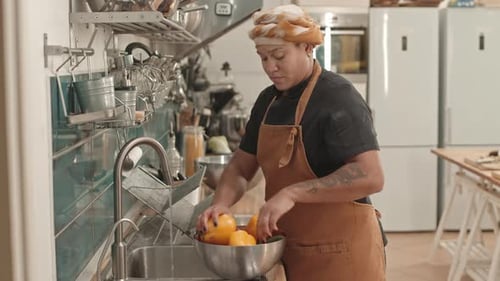 Chef Washing Colorful Vegetables in Commercial Kitchen