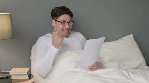 Man in Bed Reacts to Positive News