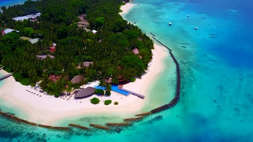 Aerial drone texture of island beach by blue water and sand background