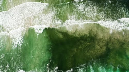 Flying Over Big Waves Crashing in the Ocean