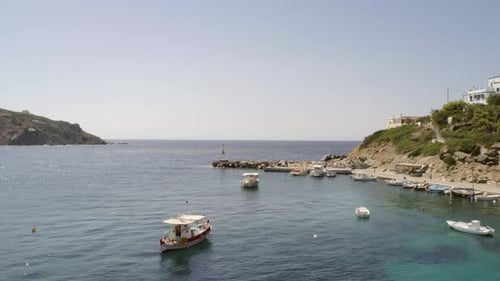 Aerial view of fishing boats anchored on the seashore in Greece.