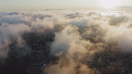 View From a Drone of City Center Above Which Clouds are Rapidly Floating