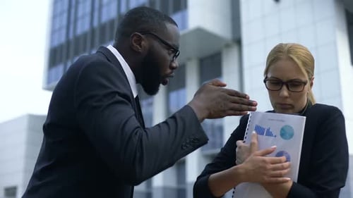 Angry Boss Yelling at Employee in Front of Office