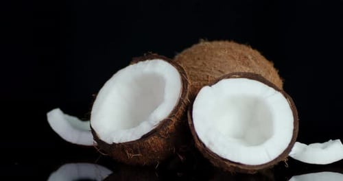 Delicious Coconuts Halved on a Black Background