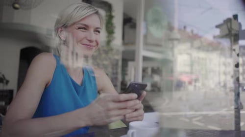 Businesswoman taking a break in coffee shop using smartphone
