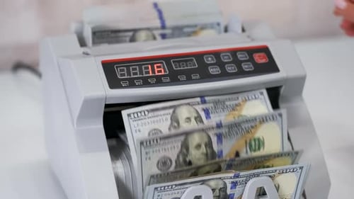 Money Counting Machine Counts US Dollar Bills