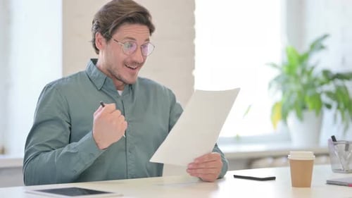Man Celebrating Good News in Office Setting