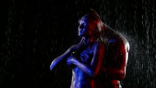 Embracing Couple in Rain with Red and Blue Lighting