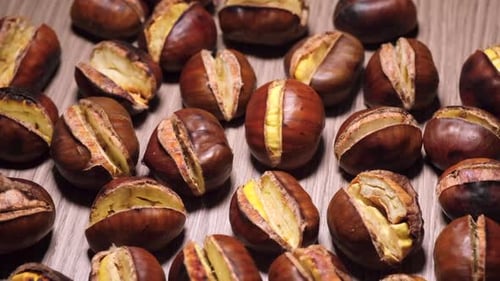 Close-Up of Roasted Chestnuts on a Wooden Surface
