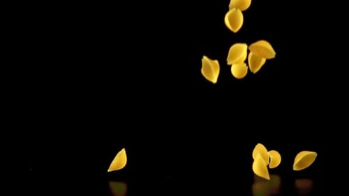 Shell Pasta Falling in Slow Motion on Black