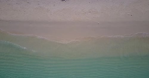 Tropical flying abstract shot of a paradise sunny white sand beach and aqua blue ocean background