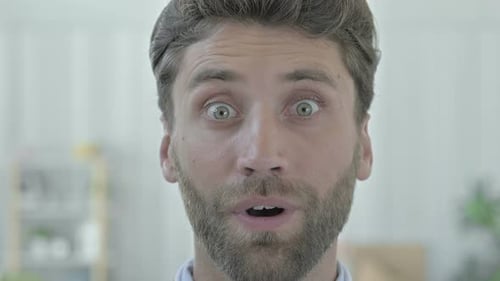 Young Adult Man Reacts with Shock and Surprise
