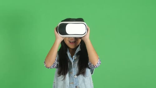 Enthusiastic Girl Using VR Headset on Green Screen