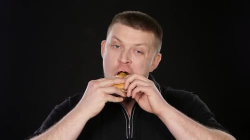 Man Enjoying a Delicious Hamburger Close Up