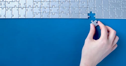 Grey Puzzles Isolated On Blue Background. Social Issue Concept