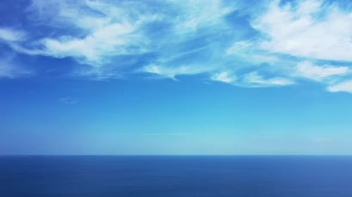 Daytime above island view of a sandy white paradise beach and turquoise sea background in high resol